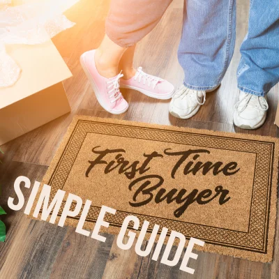 Excited couple by doormat reading "First time buyer".